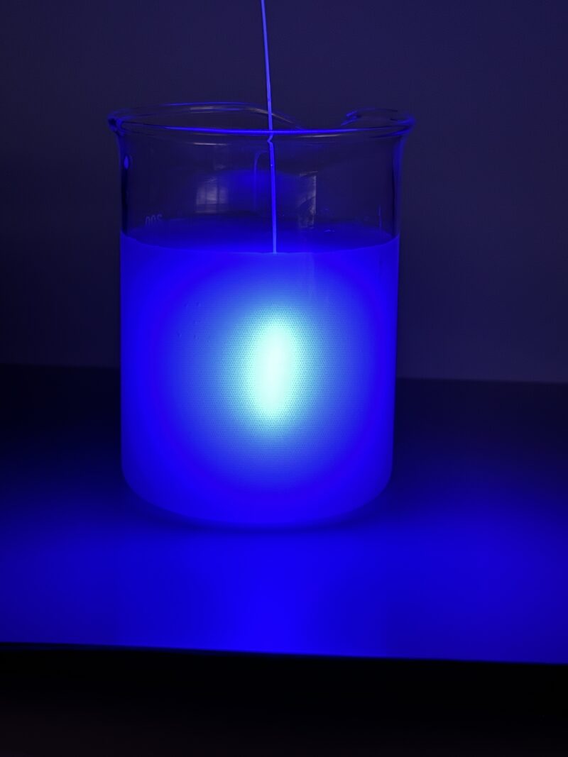 Cylindrical diffuser emitting 450 nm blue light in a vessel with scattering medium