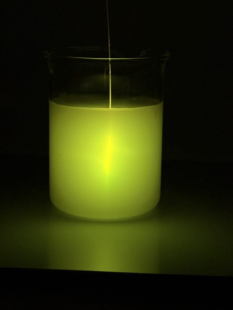 Cylindrical diffuser emitting 565 nm yellow light in a vessel with scattering medium